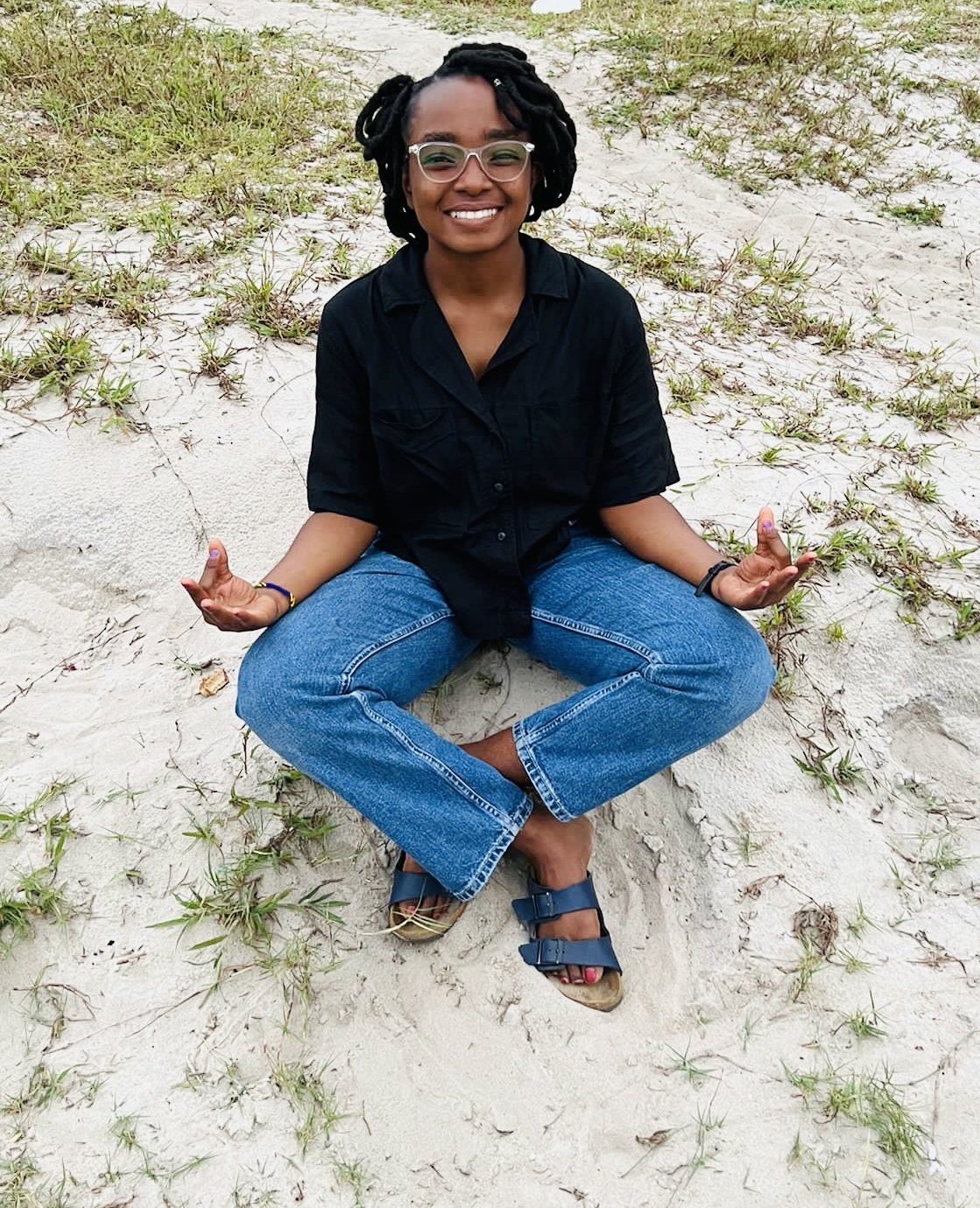 Janeth practicing yoga on a beach